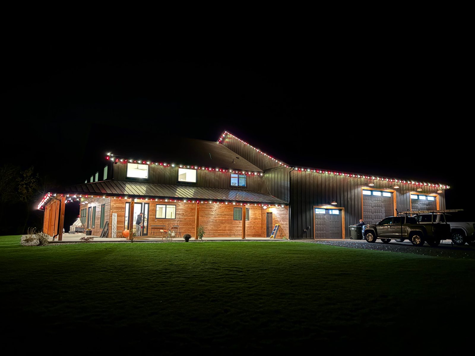 Roofline lights across a farmhouse-style home and garage