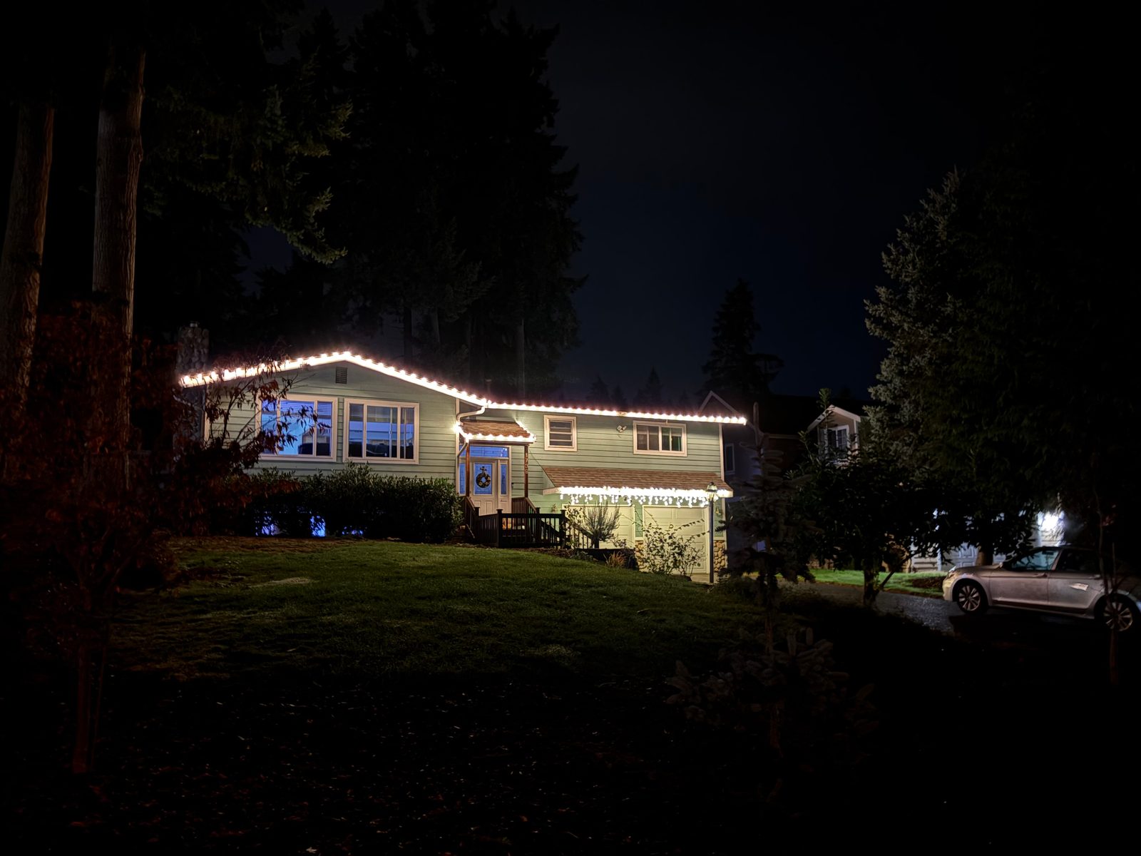 Roofline lights on a hillside home