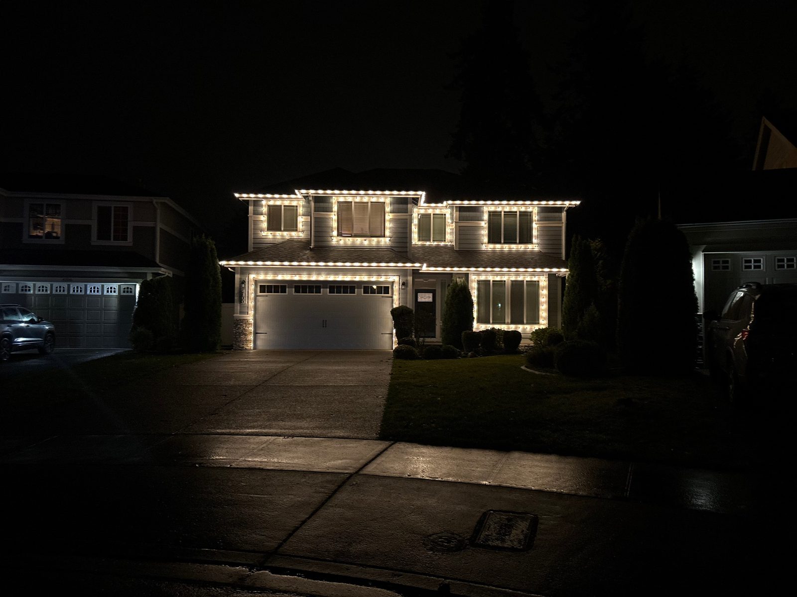 Warm white outline of the roofline and every window